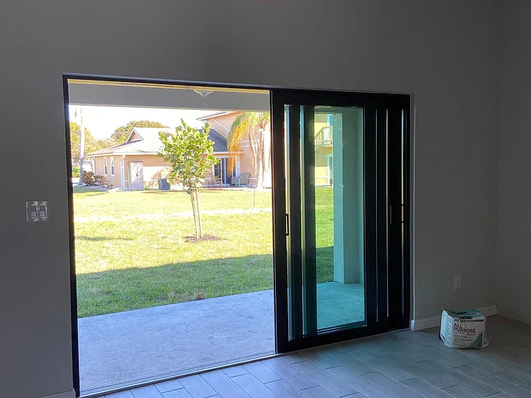 Indoor/outdoor space created by sliding patio door from 3 panels in to 1