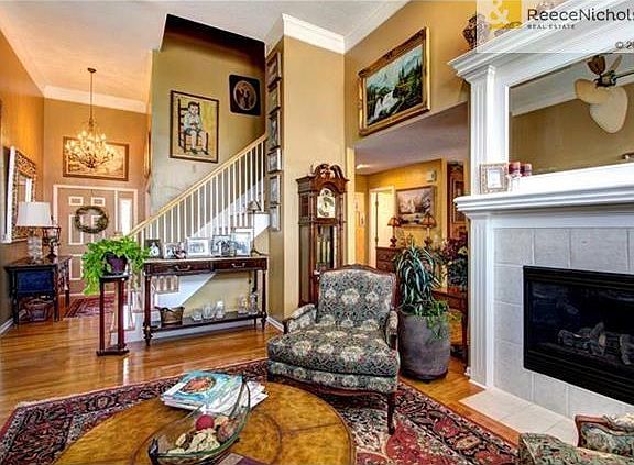 Formal living room has wonderful fireplace.  Notice the beautiful entry light fixture.