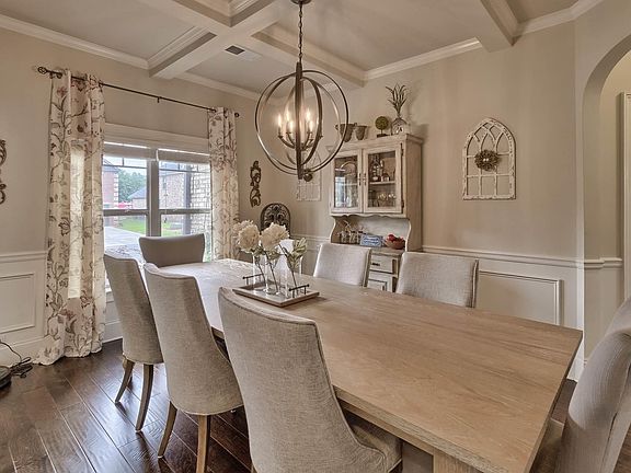 The formal ding room has wainscoting and coffered ceiling.