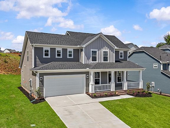 Two story home with large front porch at The Grange by DRB Homes in Clemson, SC