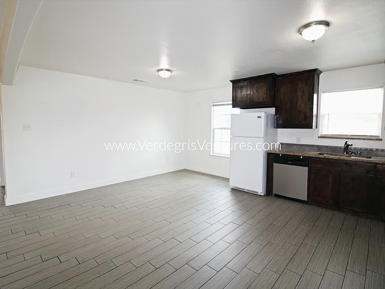 A spacious, open_concept layout connecting the kitchen, living, and dining areas.
