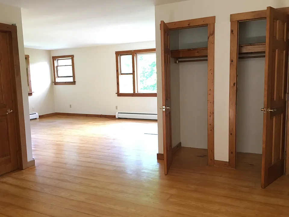 Dining area with closets, looking into living room