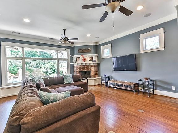 The family room has a massive picture window overlooking the covered porch and sparkling pool area.  It also features custom trim work, window seat along with wonderful hardwoods.
