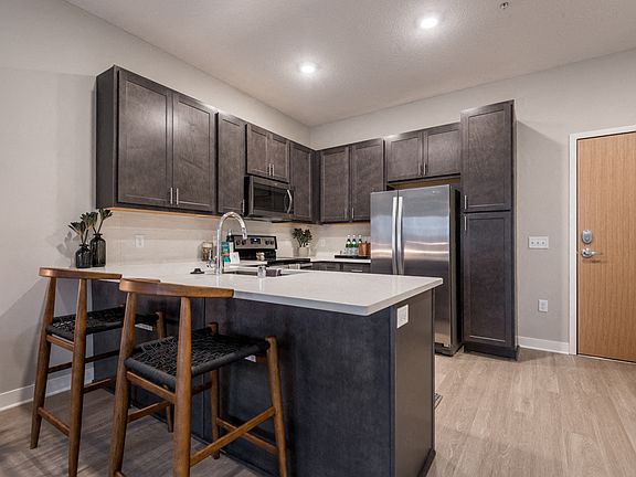A modern kitchen with rich cabinetry and sleek finishes makes every meal feel like an experience.