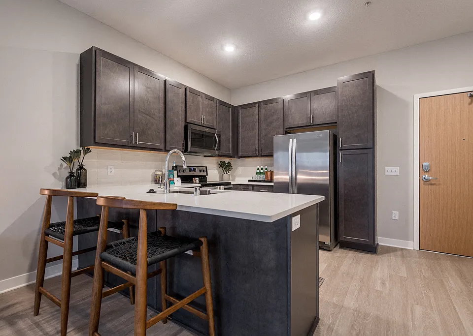 A modern kitchen with rich cabinetry and sleek finishes makes every meal feel like an experience.
