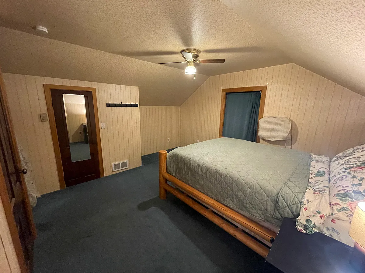 Wall mounted AC unit by window, thermostat controlled heating in bedroom. - 5th St