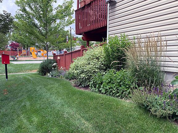 Street facing side of townhouse with back porch and playground.