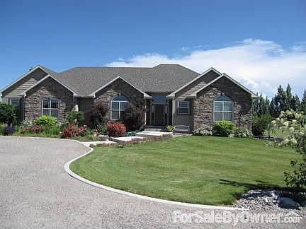 Front view of the home, circle driveway