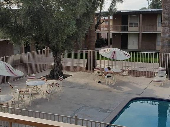 The BBQ area and Umbrella Tables surround a large pool. The Activities room is located next to the pool and is available to reserve for your next get together or meeting.