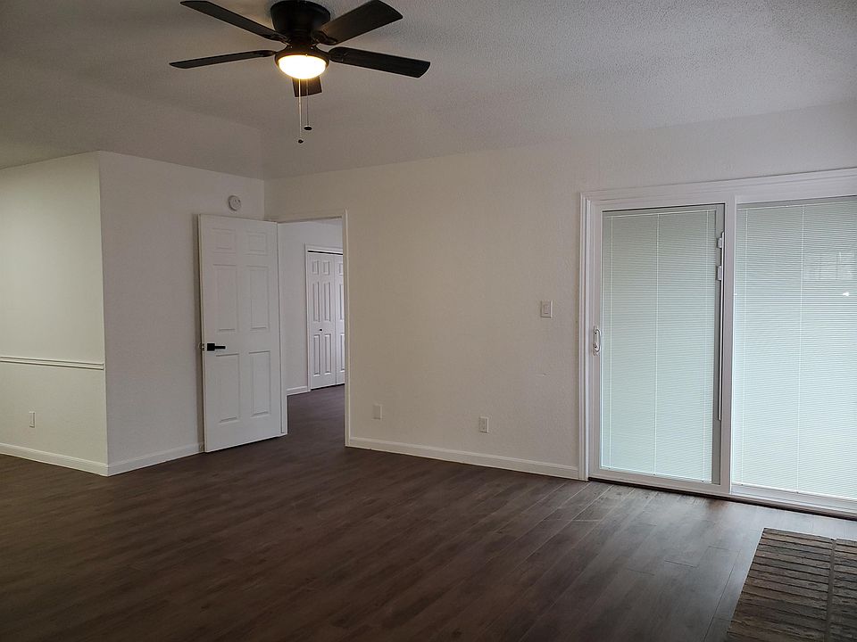 Living room with view of primary bedroom door
