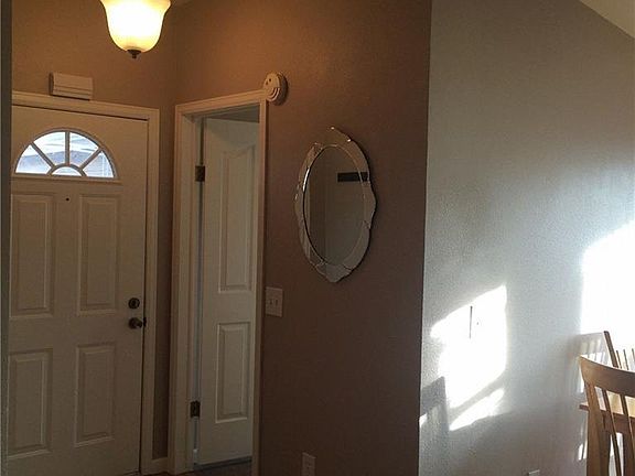 Front door with adjacent laundry room and garage access