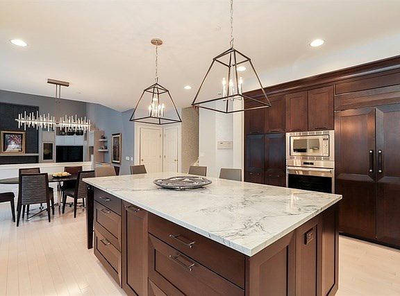 Large center island with quartzite countertop and breakfast bar