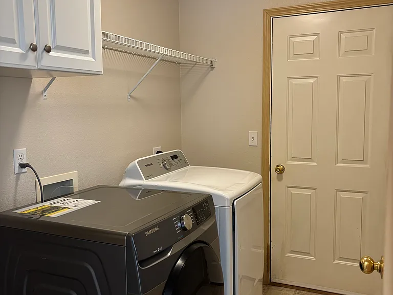 Laundry room with garage access. Washer and dryer included.