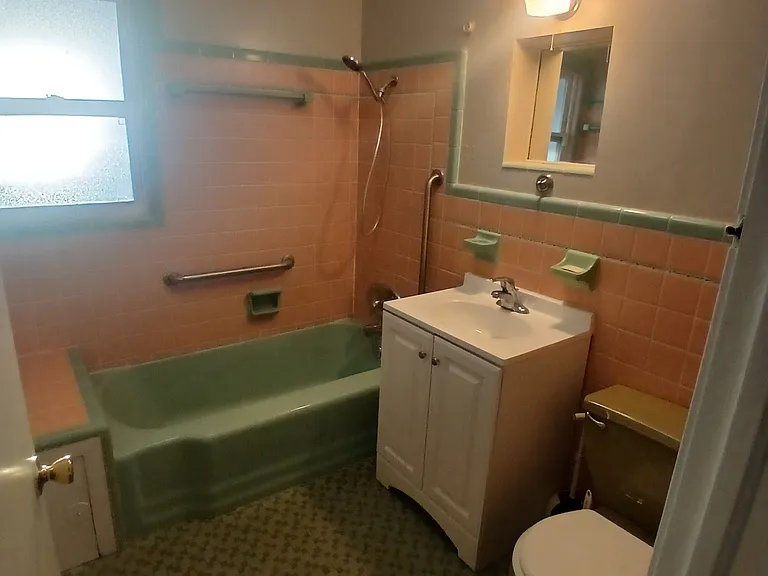 Bathroom from another side, shower tub combination.