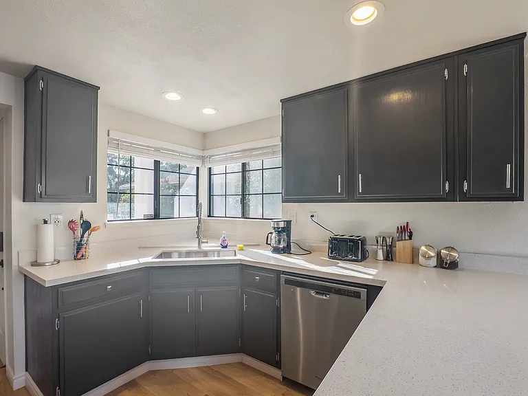 Enjoy cooking in the upgraded kitchen, complete with sleek granite countertops and a full suite of stainless steel appliances, including a refrigerator, range, microwave, and dishwasher.