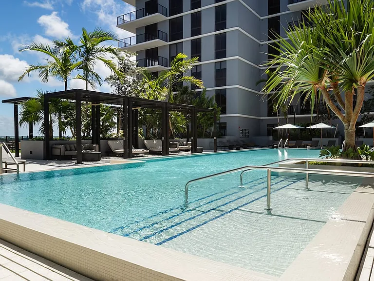 Resort-style pool and sundeck with cabanas