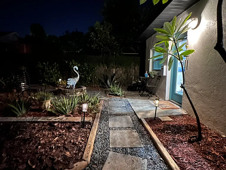Private gated entrance with lit pathways