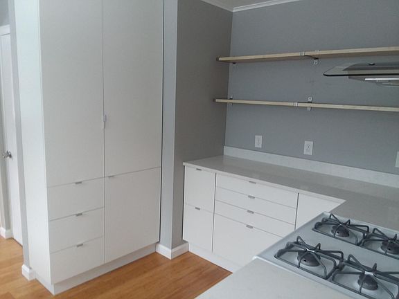 Kitchen w/quartz counters, gas stove, and IKEA cabinets