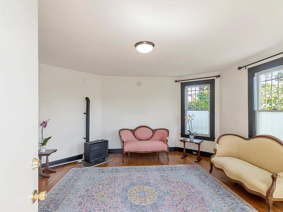 Living room. Refinished original oak floors. Gas wall heater. Sunny and bright with tons of natural light. Fresh paint.