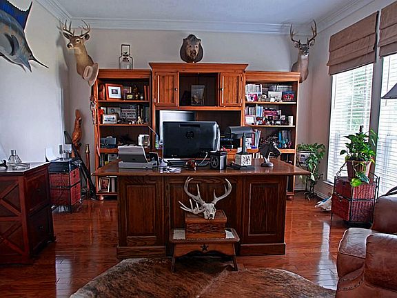 This Study/Office space is ideal for those who work from home.  The double crown molding adds a touch of class and elegance while the gleaming hardwood floors give it a masculine feel.  This combination is a classic desisgn that most prefer.