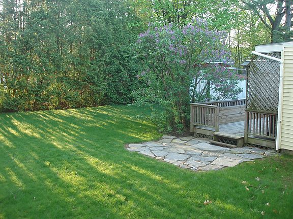 Private Backyard with porch deck and 2 storage sheds