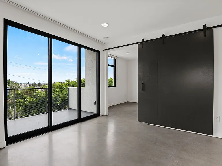 Living Room Space with patio and Bedroom with Sliding Door