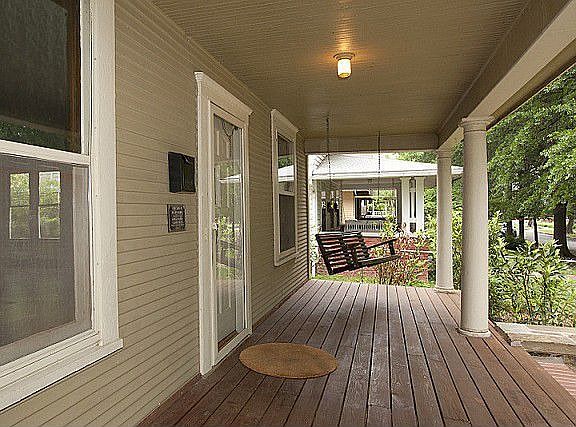 Spacious covered porch with a relaxing swing