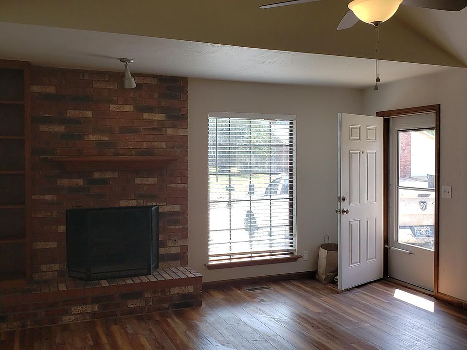 Living Room Entry into Large Living Area with Beamed Ceiling