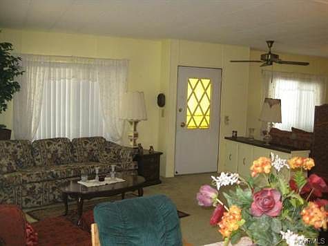 Living room and entry door from formal dining area.