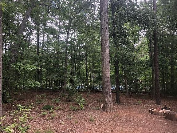 Fenced in backyard overlooking tennis courts