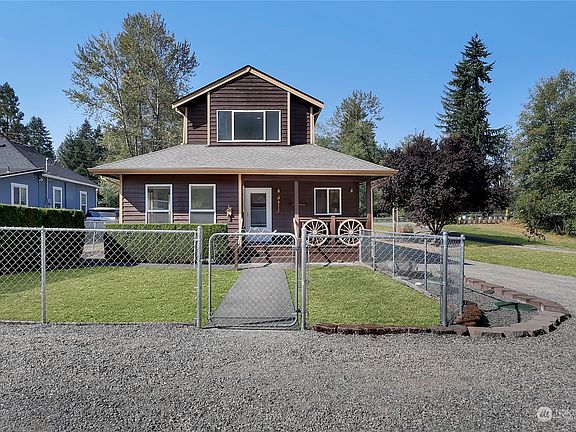 Fenced yard & walkway that leads to a covered country porch.>
