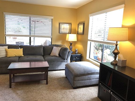 Light and bright with custom paint, sliding glass door to private deck, and popcorn scraped from ceilings