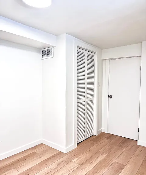 Bright bonus room C, 90 sqft. with wall art. Window facing south back yard.