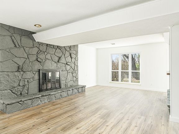 Basement living area with wood burning fire place. Great for family area or game room