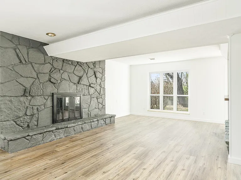 Basement living area with wood burning fire place. Great for family area or game room
