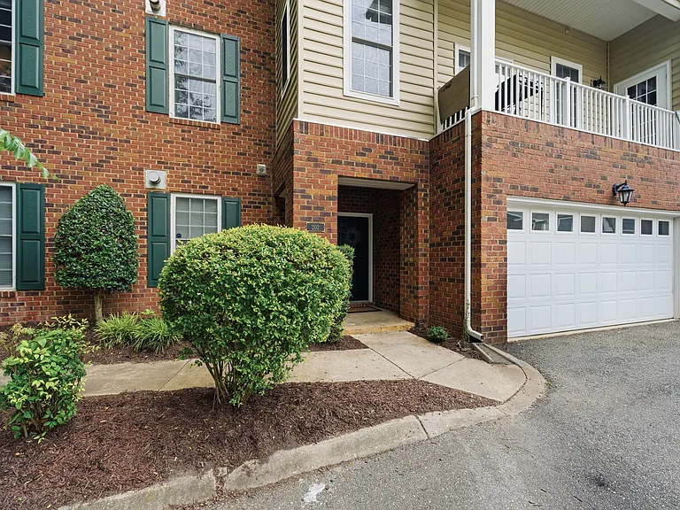 Front porch, garden, sidewalk and parking area