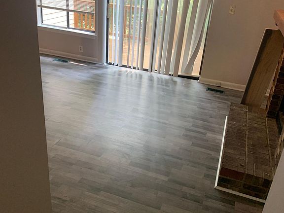 Living room with wood burning fireplace. French doors onto deck
