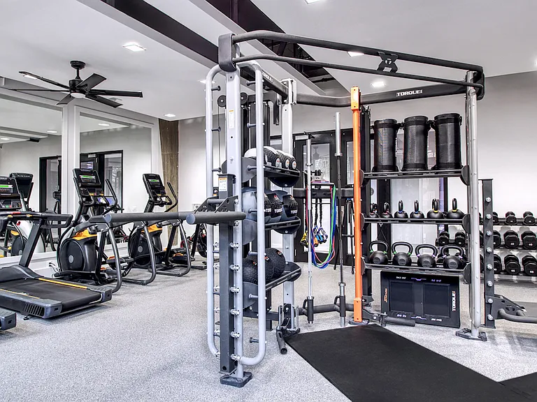 24-hour fitness center with cardio equipment and free weights