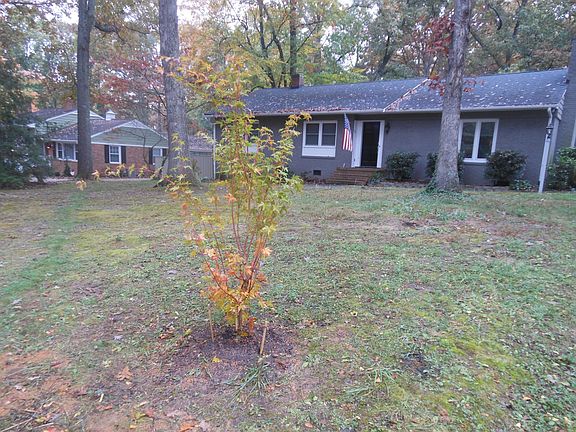 View of home in the fall. Red bark maple.