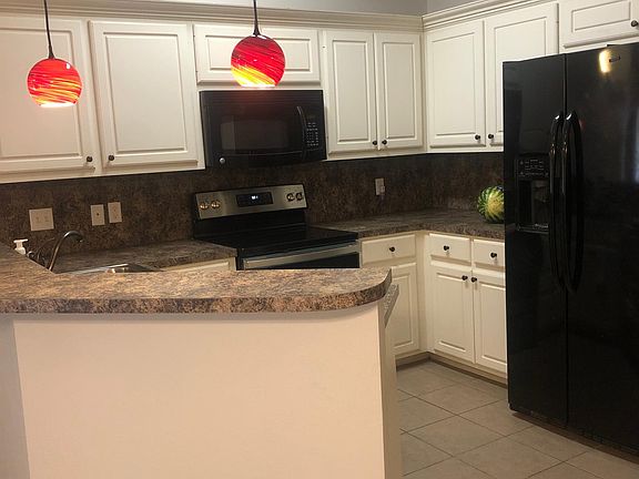Kitchen with bar area opening to Living/Dining areas