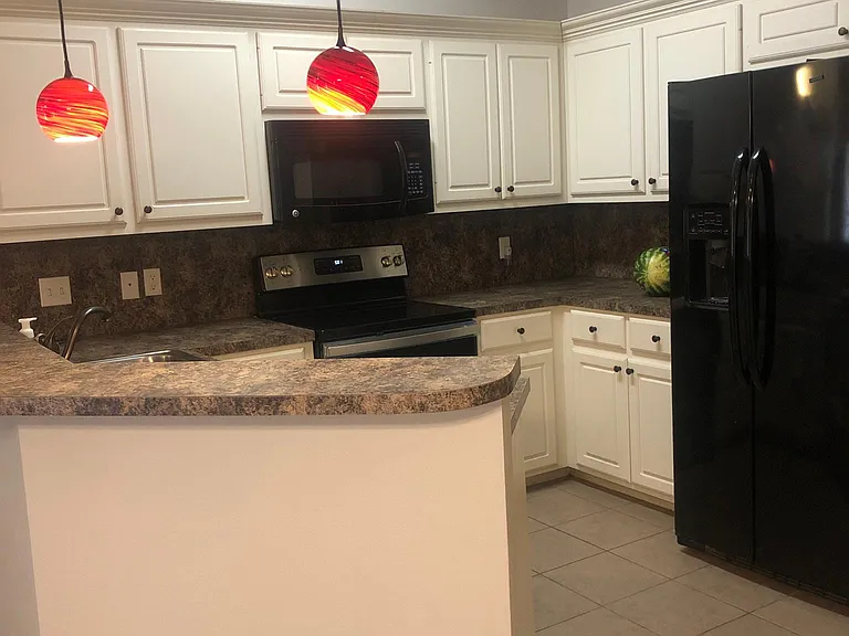 Kitchen with bar area opening to Living/Dining areas