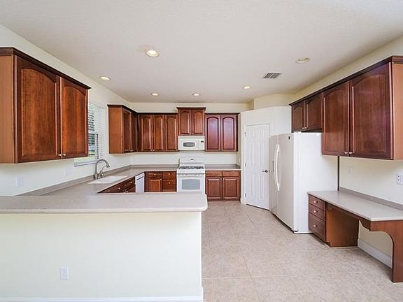 Ceramic tile in the kitchen. Large kitchen features a breakfast bar. And, the built-in desk has three drawers.