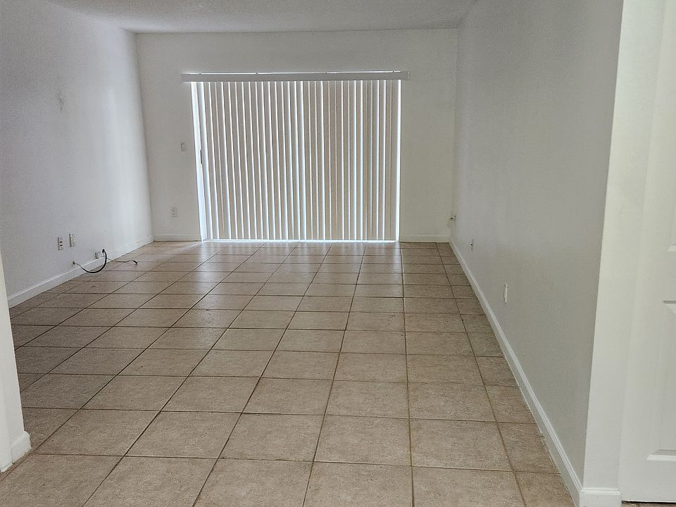 Living room leads to small screened porch.