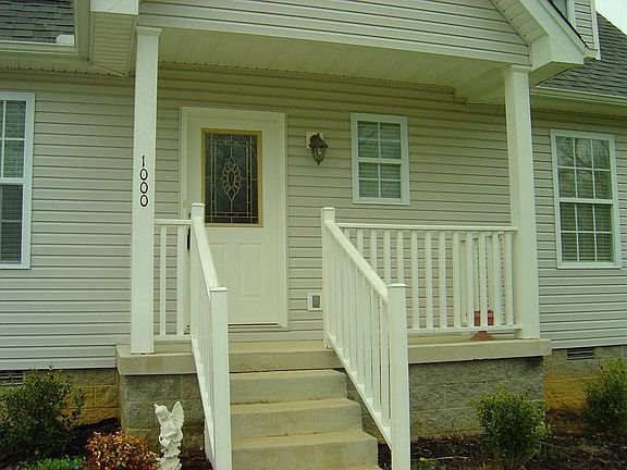 Inviting porch, lovely leaded glass door!