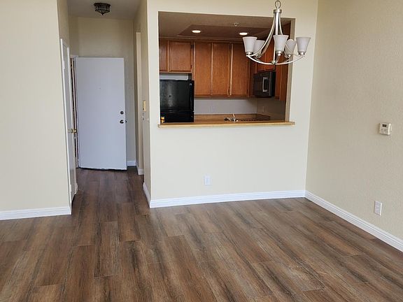 View from Living Room to Front Entrance/ Closet, Dining Room to Kitchen