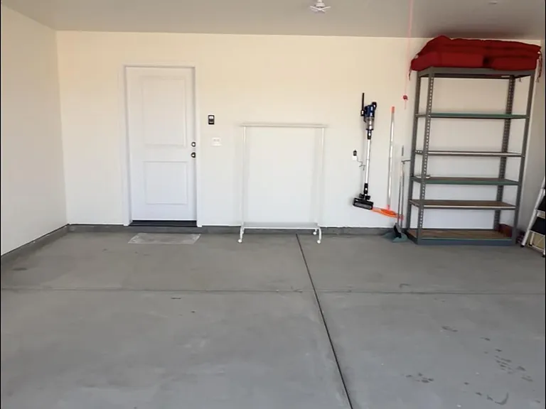 Double car garage, automatic door, shelving for storage.