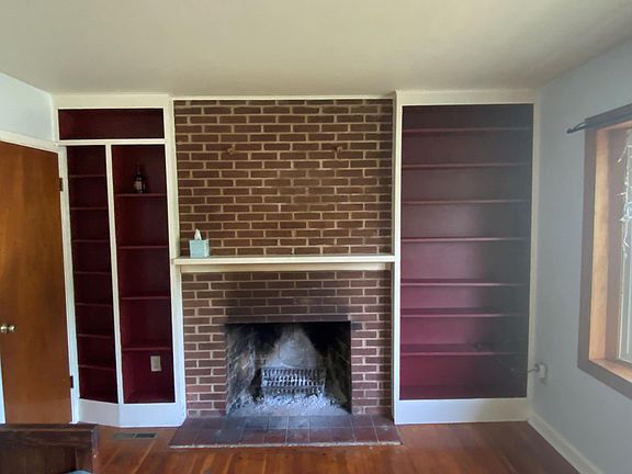 Living Room with wood burning fireplace and built in shelving