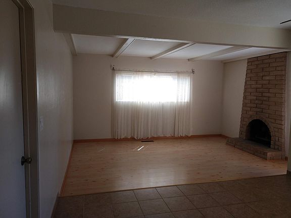Family room with wood burning fireplace.