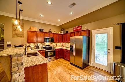 Granite countertops, stainless appliances and cherry cabinets