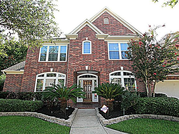 EYE-CATCHING CURB APPEAL, LANDSCAPE LIGHTING, AND A WALKWAY FROM THE DRIVEWAY TO THE COVERED ENTRY GREETS YOUR GUESTS AS THEY ARRIVE